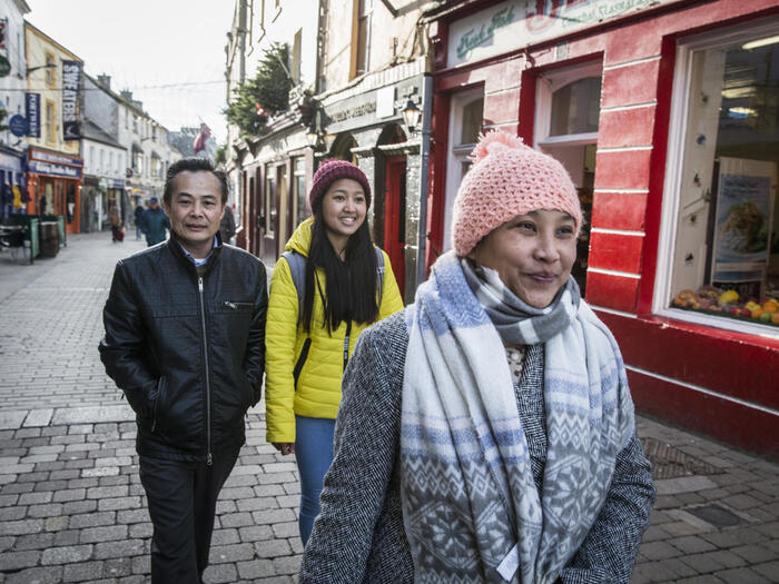 Reunited refugee family from Myanmar walking the streets of Galway in Ireland
