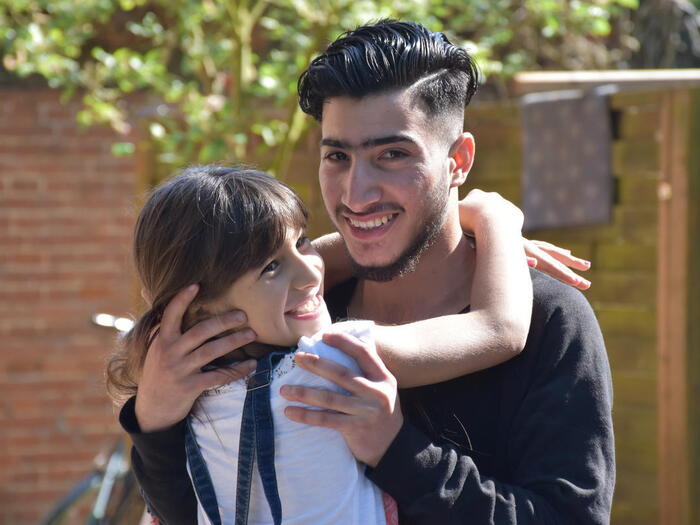 Syrian refugee, Numeir, hugging his sister after reunification in Germany