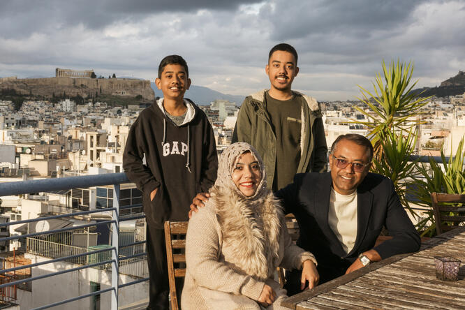 Rphingya refugee family posing for a photo in Greece