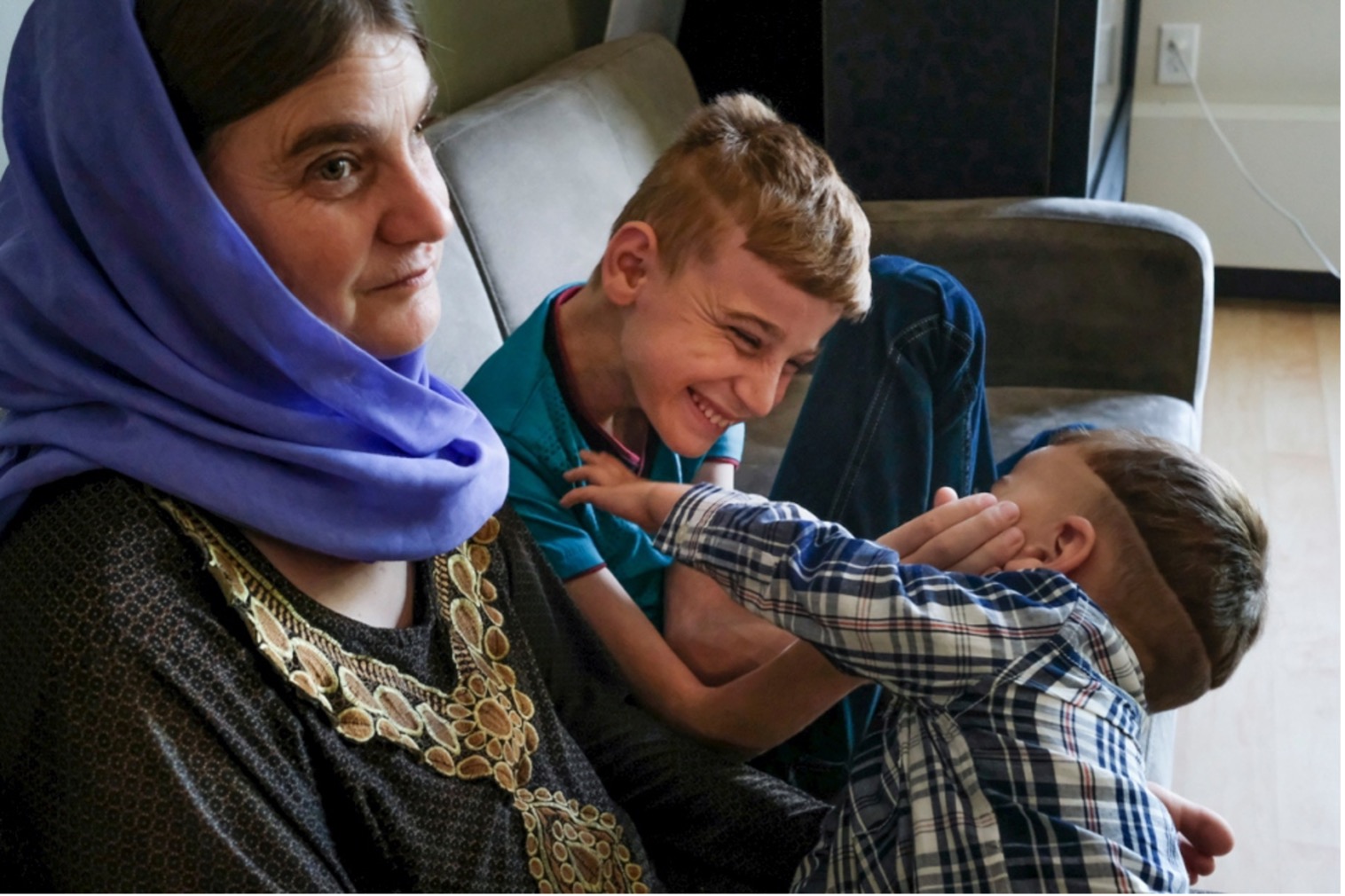 Iraqi boy, Emad, plays with his brother after being reunited with his family in Canada.