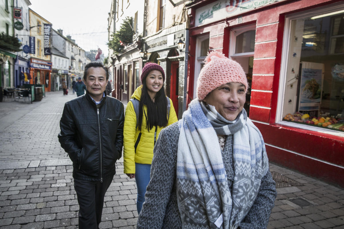 Reunited refugee family from Myanmar walking the streets of Galway in Ireland