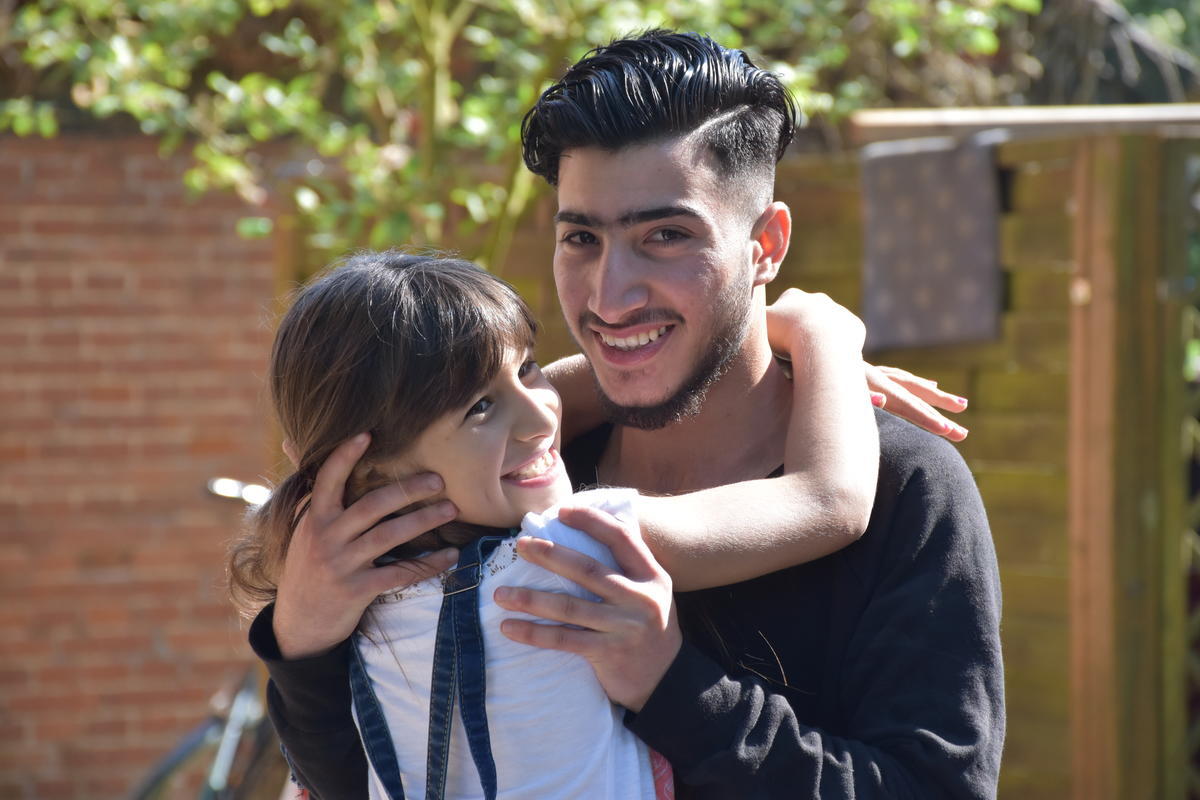 Syrian refugee, Numeir, hugging his sister after reunification in Germany Syrian refugee, Numeir, hugging his sister after reunification in Germany