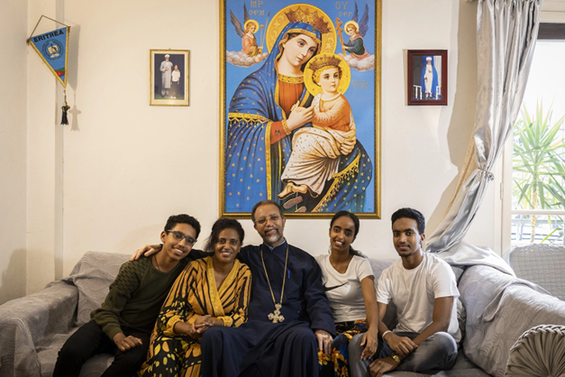 Family members posing for a photo at home